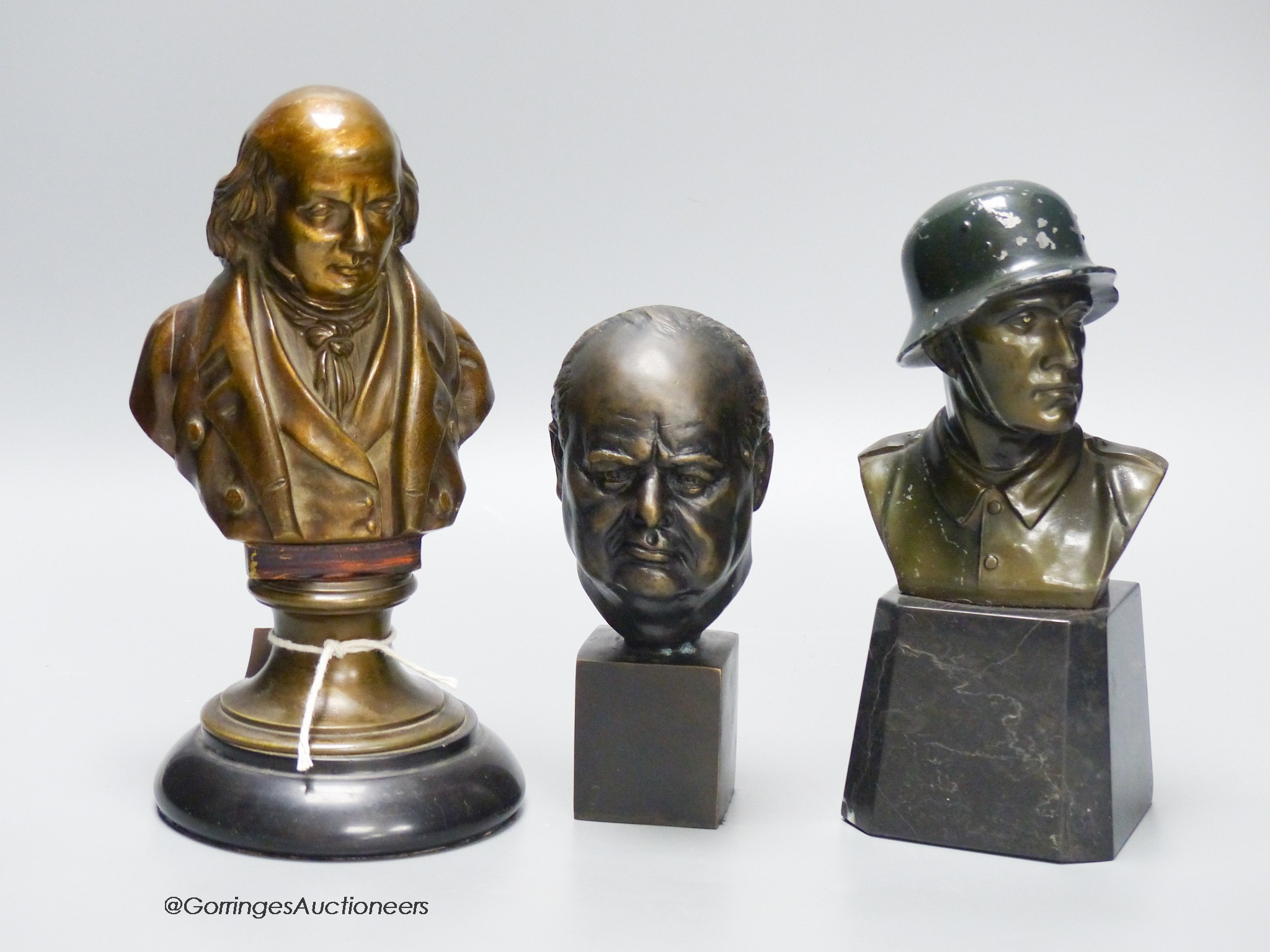 Three cast metal portrait busts, tallest 22cm